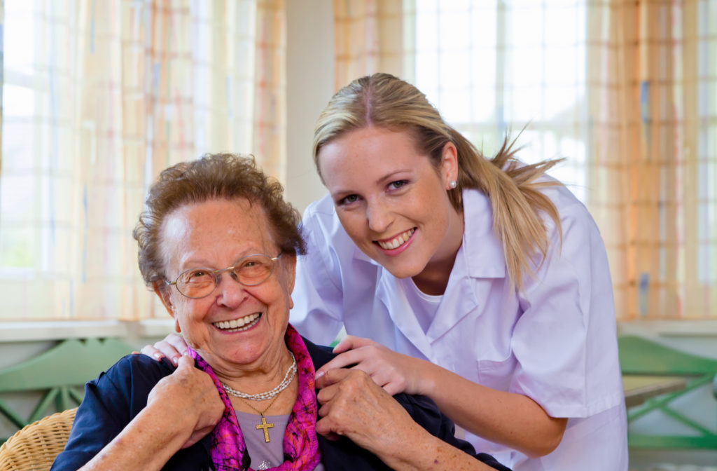 Happy nurse and happy senior women at senior community