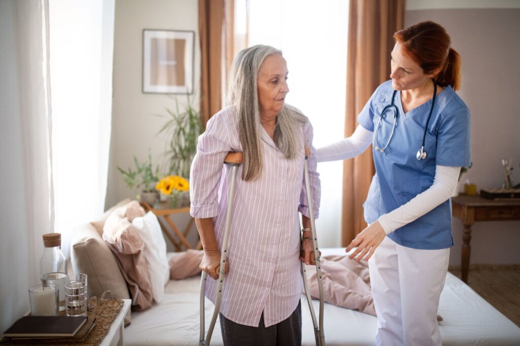 A senior person getting assistance from a caretaker in an assisted living senior community